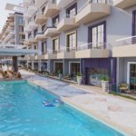 Luxury swimming pool at Lavanda surrounded by elegant architecture and a serene resort atmosphere.