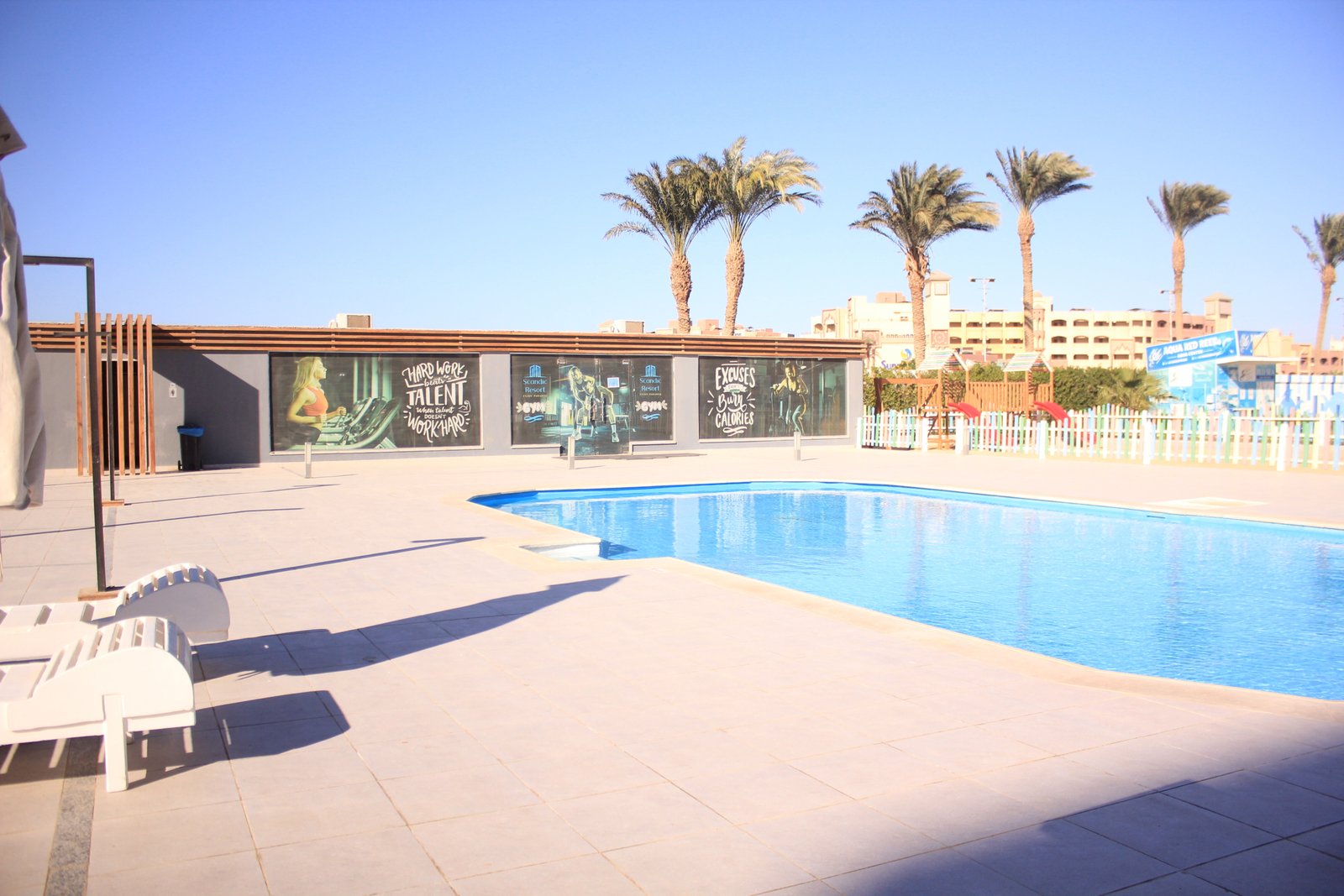 Residents enjoying the swimming pool surrounded by Scandinavian-style buildings at Scandic Hurghada.