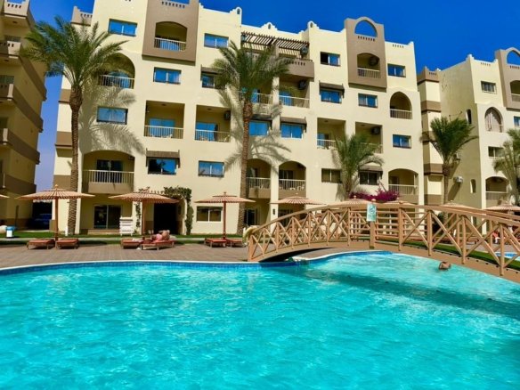 Front view of AlKarma Aqua Beach showcasing elegant modern seaside architecture and luxurious design.