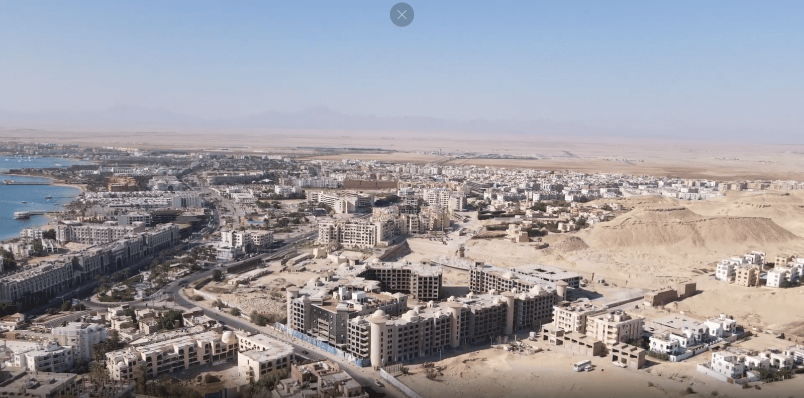 Aerial view of Atlantis Hurghada showcasing luxury apartments, pools, and landscaped gardens near the Red Sea.