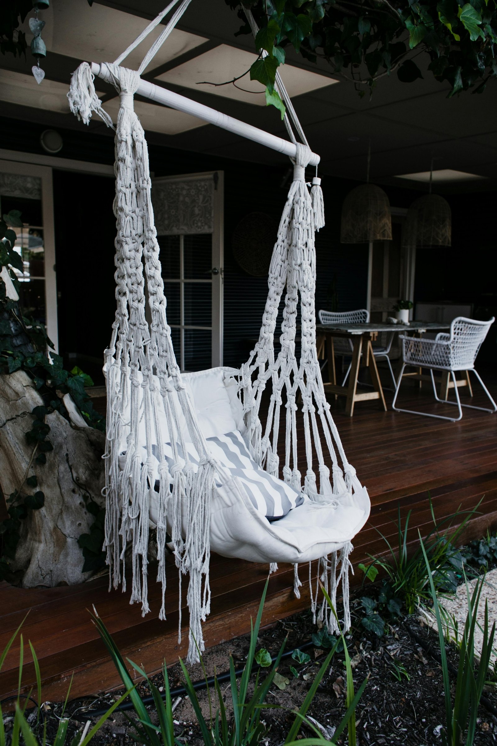 Outdoor living space featuring a modern patio, comfortable seating, landscaping, and entertainment area