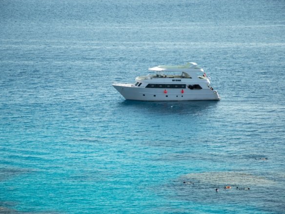 A luxurious standalone villa featuring a mix of modern and traditional Nubian architecture, featuring a private sandy beach directly on a crystal-clear salt-water lagoon in El Gouna.