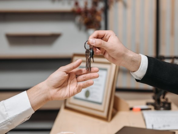 Landlord reviewing rental agreement with new tenants before signing a lease.