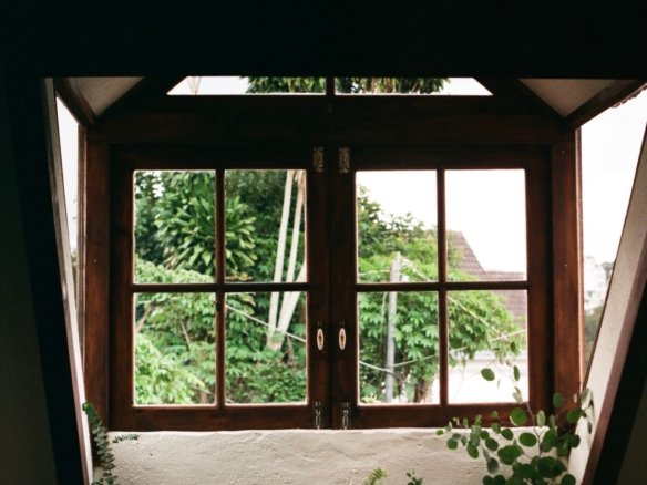 Natural Light streaming through large windows into a bright, modern living room with an open layout.