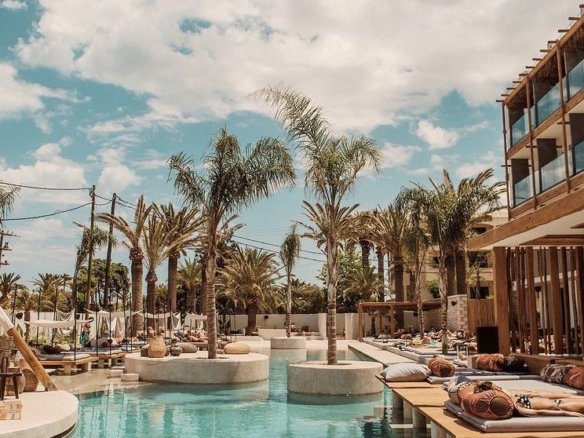 Landscaped gardens, lagoon swimming pools, and shared facilities inside the Touristic Villages.