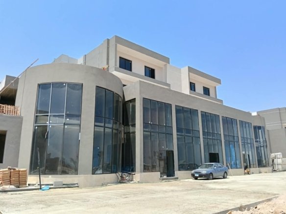 Outdoor commercial promenade featuring retail shopping brands and cafes at Platinum Resort Hurghada.