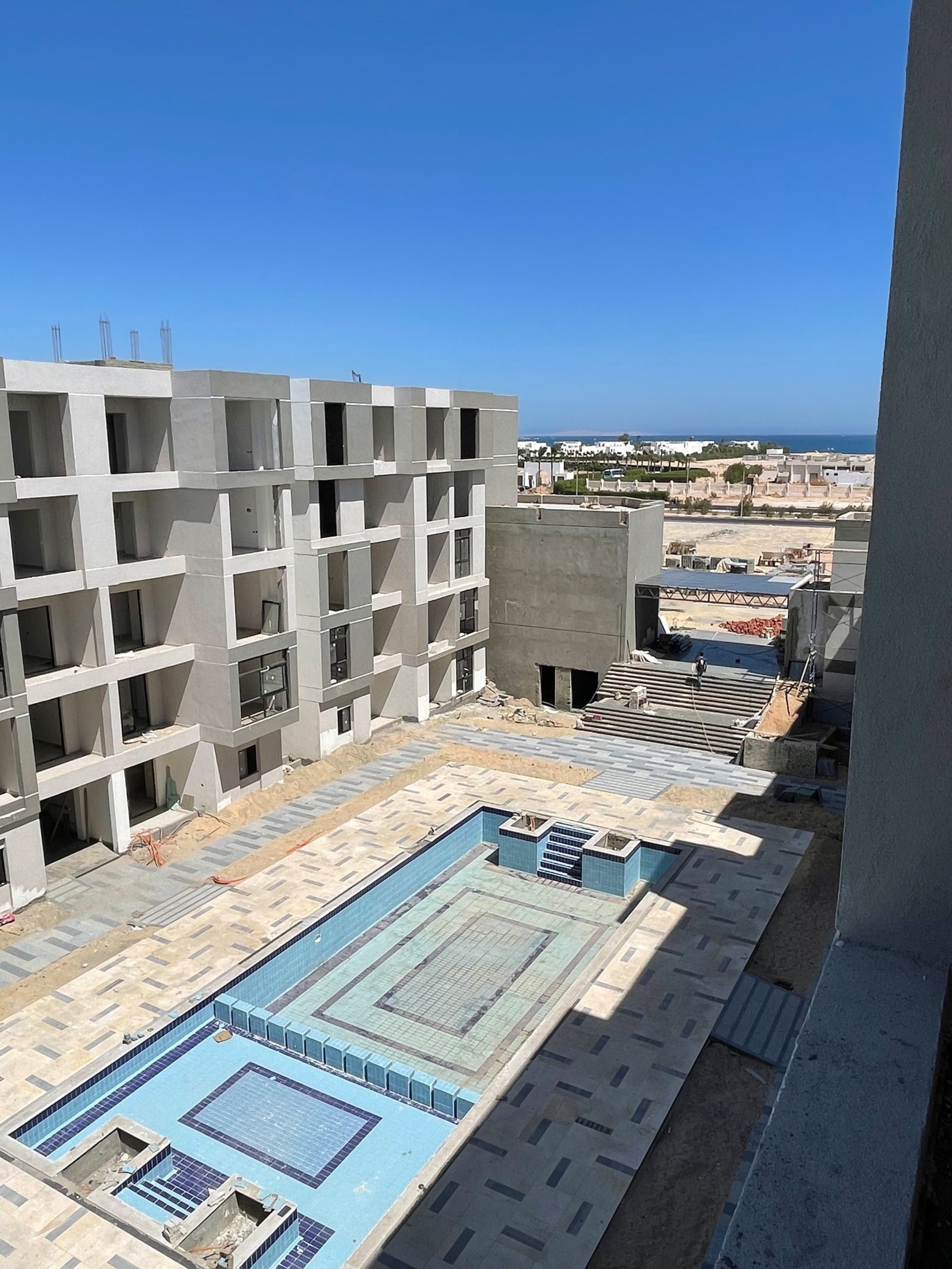 Modern exterior architectural facade of Platinum Resort Hurghada building at sunset.