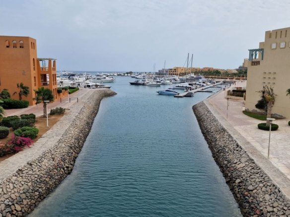 Shuttle boat water taxi navigating through the blue lagoon canals connecting El Gouna neighborhoods