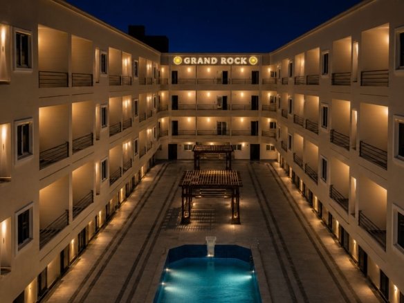Luxury resort swimming pool area at Grand Rock Hurghada with integrated kids aqua park and sun loungers.